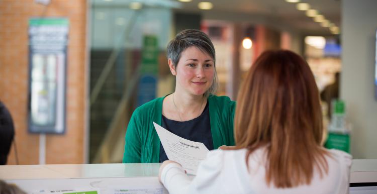 Woman speaking to a receptionist
