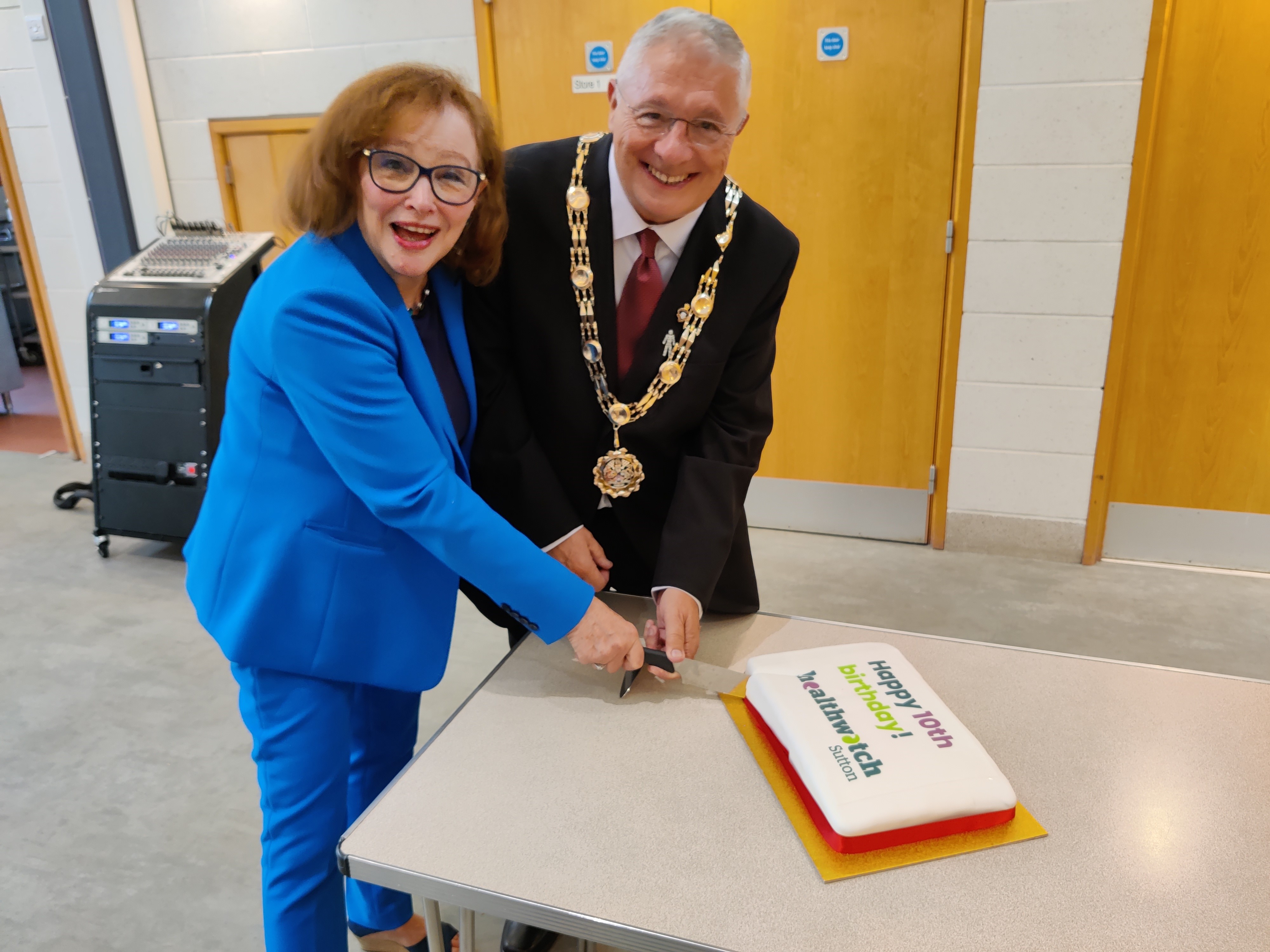 Our chair, Barbara McIntosh, and the Mayor of Sutton cut the cake