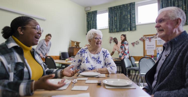 People chat in a community centre