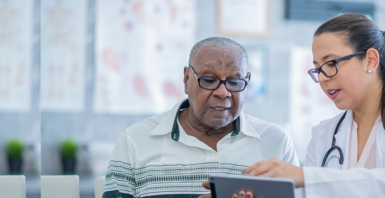 Doctor shows computer screen to patient