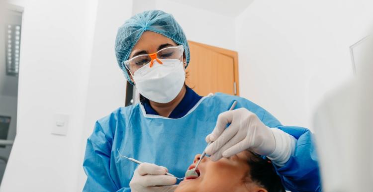 Dentist examines patient's teeth