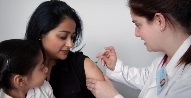 Doctor gives woman an injection