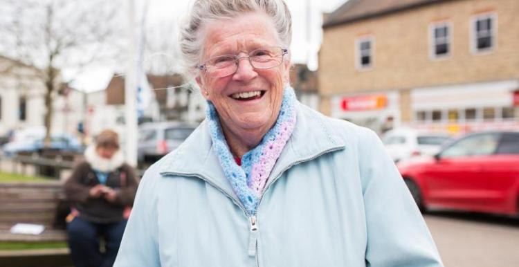 Elderly woman smiling face on to the camera