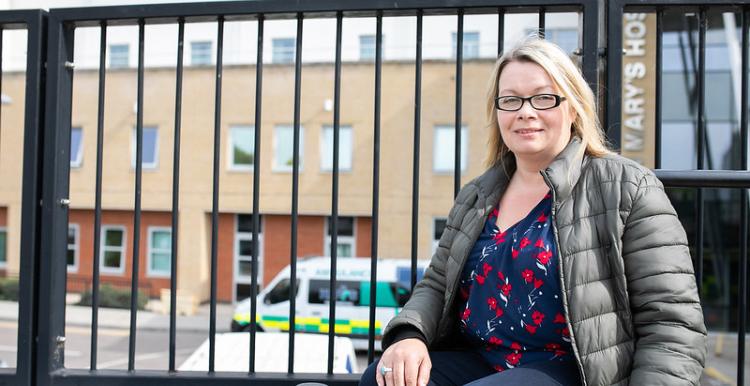 woman sitting outside hospital