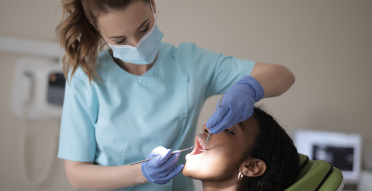 Dentist examines patient Dentist examines patient