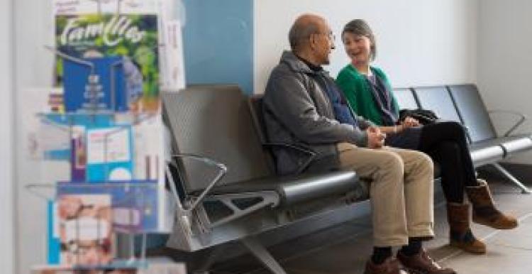 man and woman talking in waiting area 