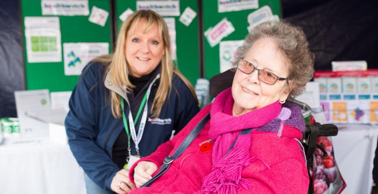 Healthwatch volunteer speaking to an elderly lady at an event