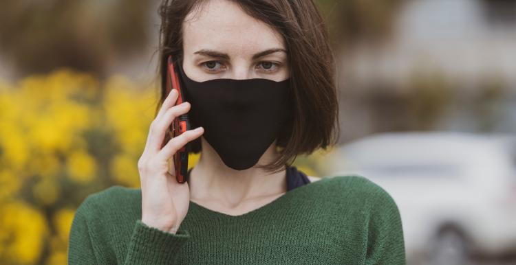 woman wearing a mask talking on a mobile phone