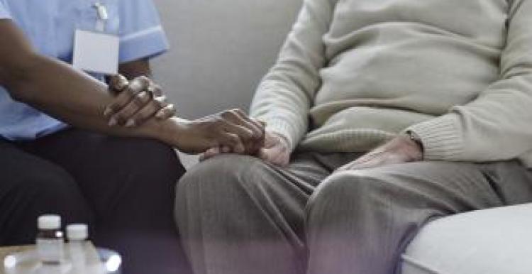 Nurse holding patient hand 