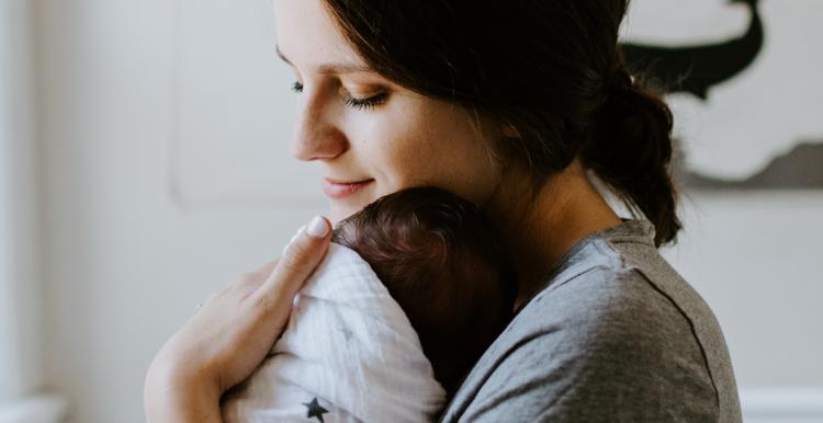 woman holding a new born baby