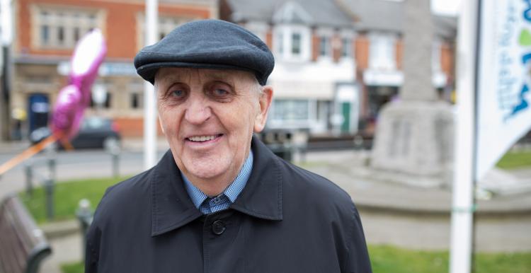 older man smiling at the camera whilst standing outside older man smiling at the camera whilst standing outside