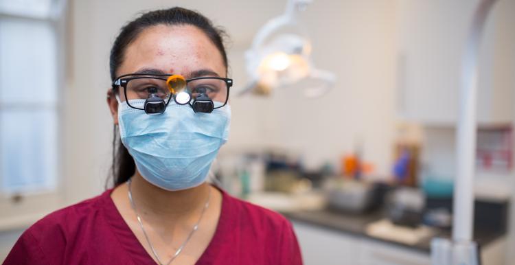dentist wearing a mask looking at the camera