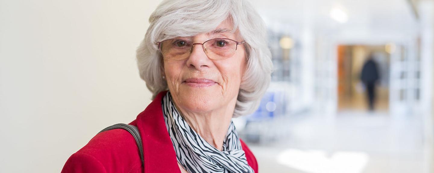 older woman standing in hospital corridor 