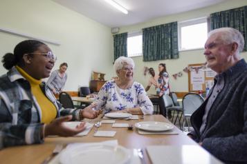 People chat in a community centre