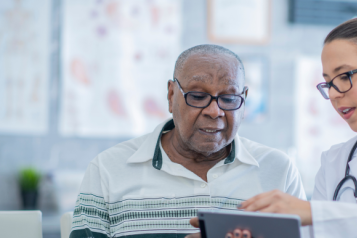 Doctor shows computer screen to patient