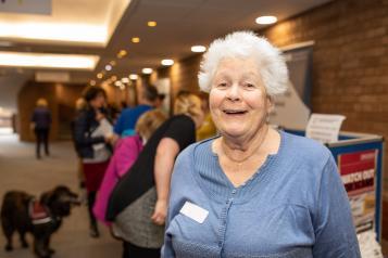 older woman standing in hallway