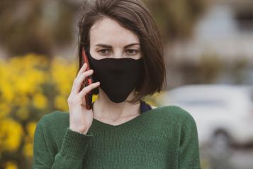 woman wearing a mask talking on a mobile phone 