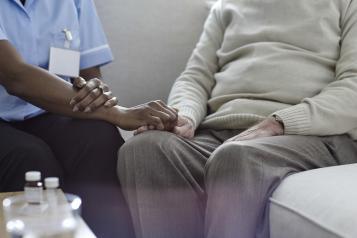 Nurse holding patient hand 