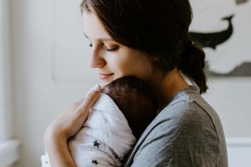 woman holding a new born baby