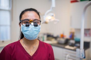 dentist wearing a mask looking at the camera