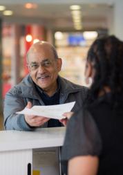 elderly man talking to receptionist