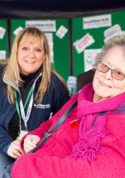 Healthwatch volunteer speaking to an elderly lady at an event